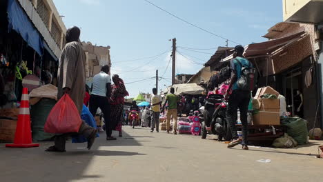 people walking in market road of dakar africa, still shot low angle