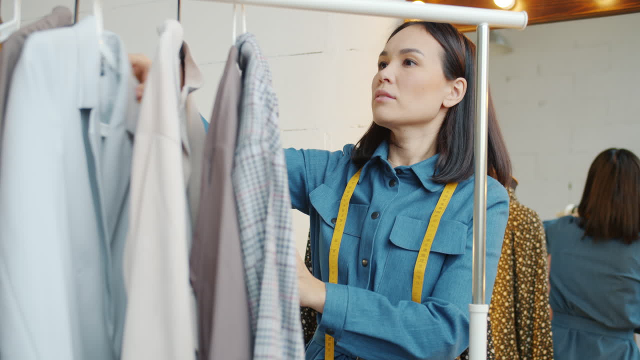 Fashion Designer Checking Clothing