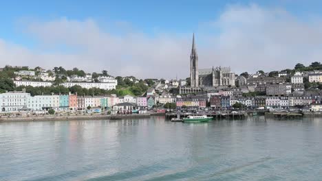 A-panorama-over-Cobh-and-cathedral-in-the-middle-on-a-sunny-day,-the-view-from-the-ship-or-boat