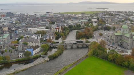 cinematic aerial dolly of galway city with rush hour traffic