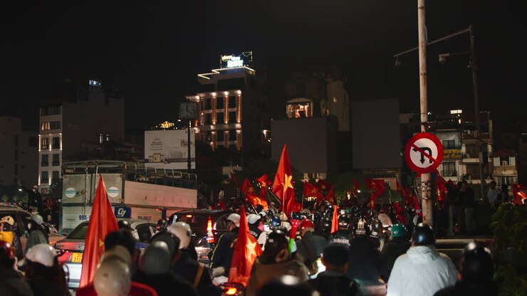 Nighttime Scene with Vietnamese Flags and People