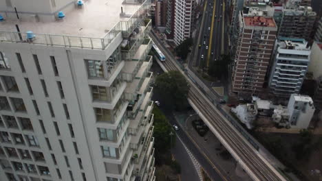 panorama of the city of buenos aires, a drone near a skyscraper, a long avenue in the distance, road junction