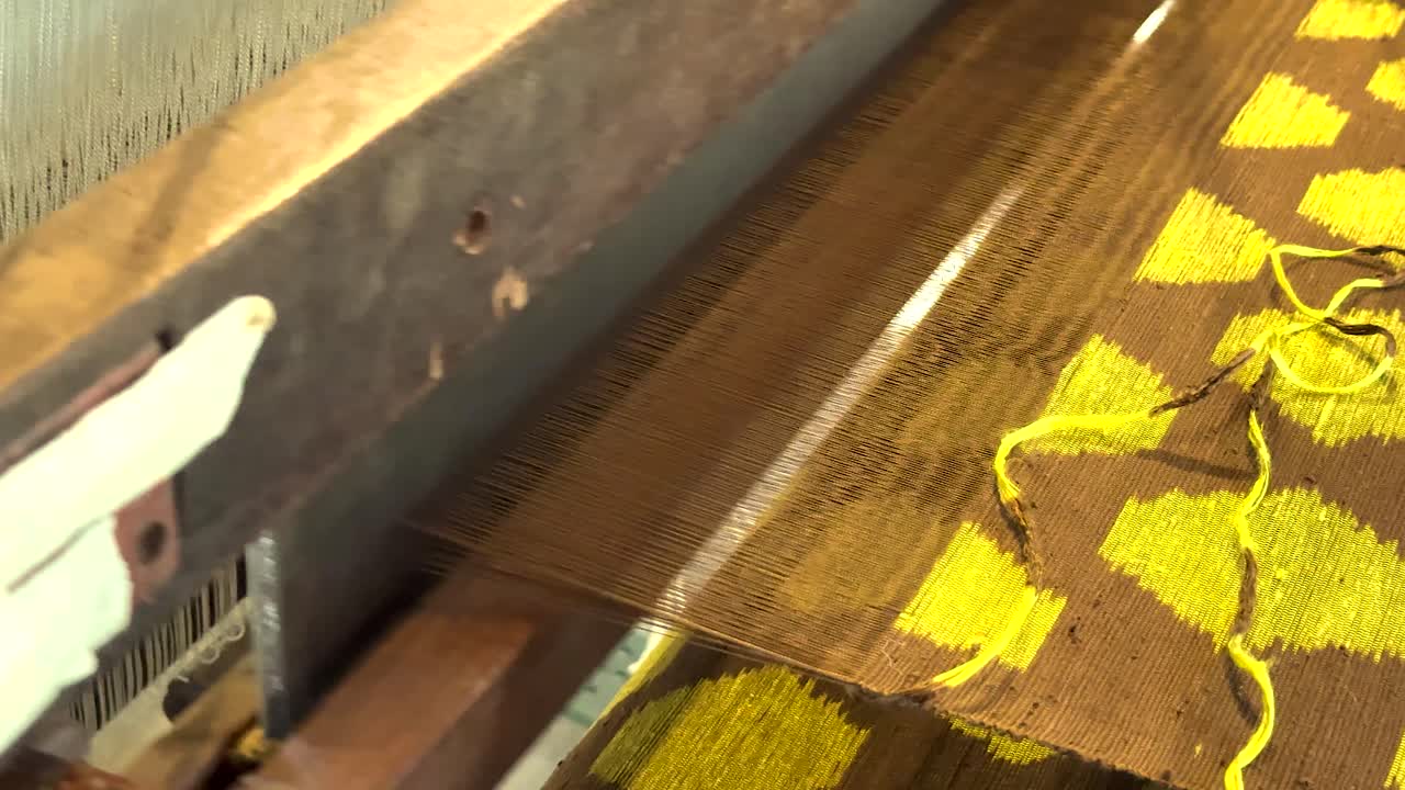 Hand weaving vibrant silk patterns in Thailand