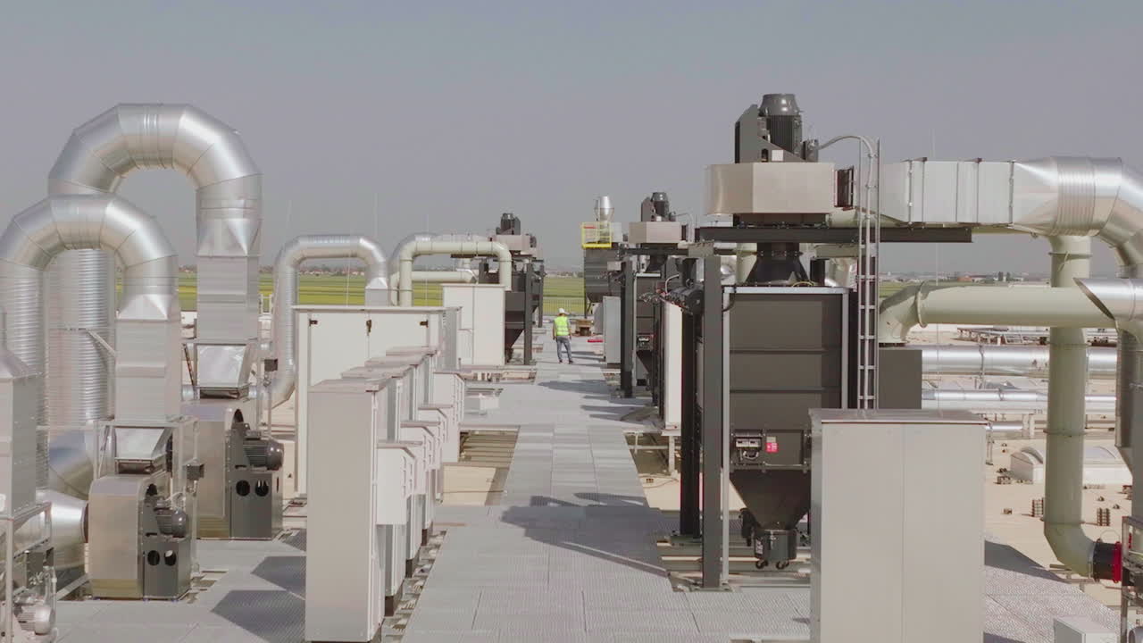 Industrial Rooftop Ventilation System with Maintenance Worker