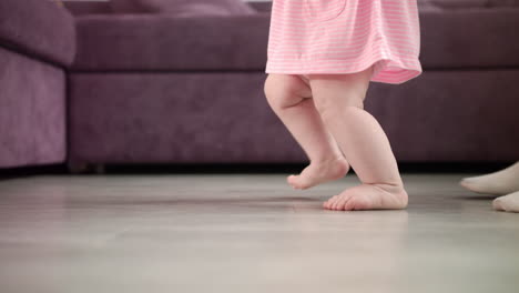 baby girl doing first steps at home