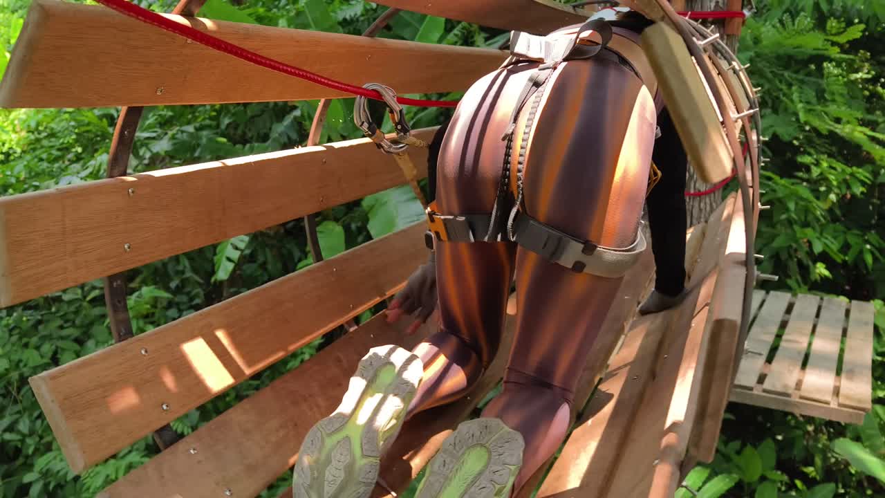 Person zip lining through a treetop adventure park