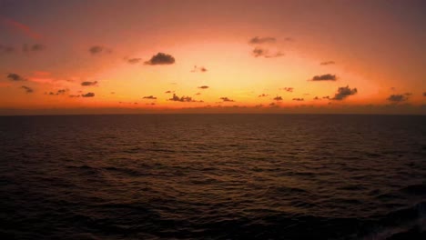 Sundown-on-the-Gulf-of-Mexico,-The-smoke-from-the-fires-in-California-have-given-an-ominous-orange-red-glow-to-the-setting-sun