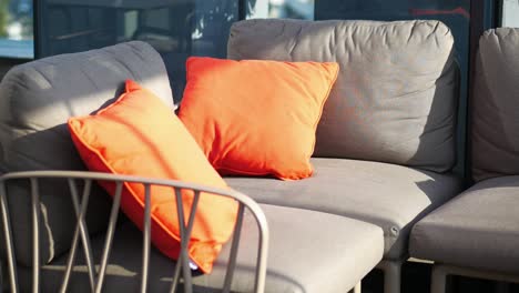 outdoor patio sofa with orange pillows