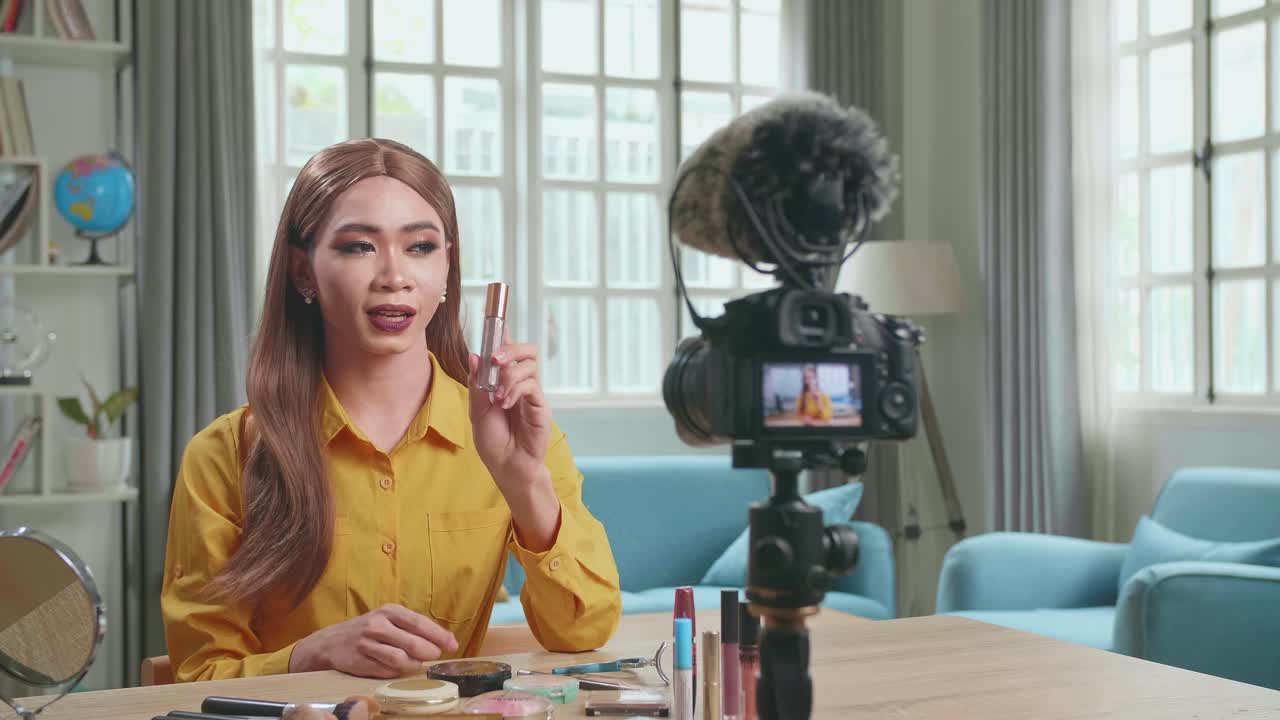 Influencer Young Transgender Woman Blogger Talks About Makeup. Transgender Woman Recording Video Blog Tells How To Be Beautiful. Blogger Talks Facial Beauty Treatments. Vlogger Broadcasts How To Use Of Cosmetic In Home Studio