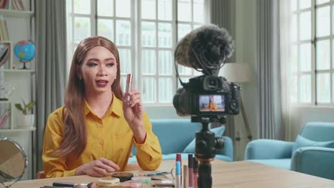 influencer young transgender woman blogger talks about makeup. transgender woman recording video blog tells how to be beautiful. blogger talks facial beauty treatments. vlogger broadcasts how to use of cosmetic in home studio