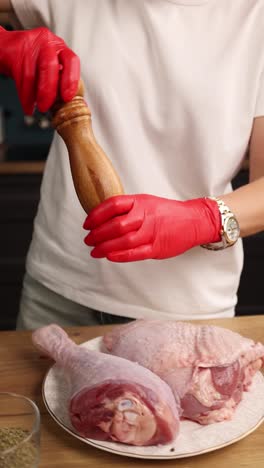 preparing raw turkey legs with gloves