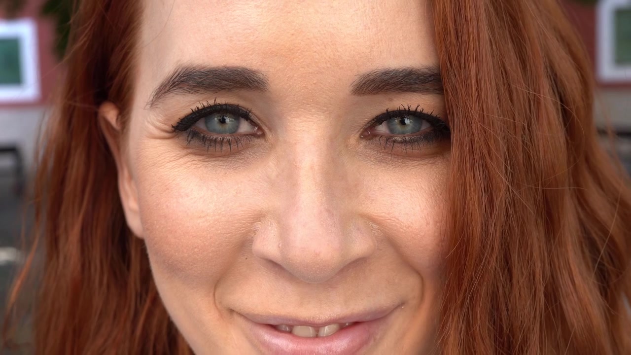 Woman s face girl opening her beautiful blue eyes