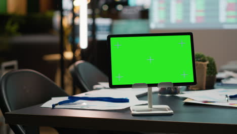 empty business workspace with a digital chroma key screen on tablet