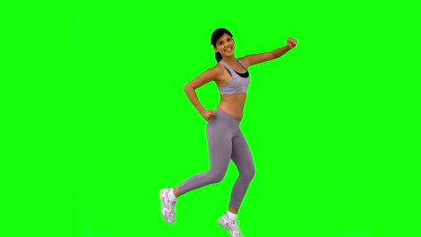 Sportliche-Frau-Springt-Und-Posiert-Auf-Greenscreen