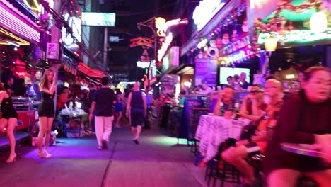 crowded street scene with neon lights and lively atmosphere