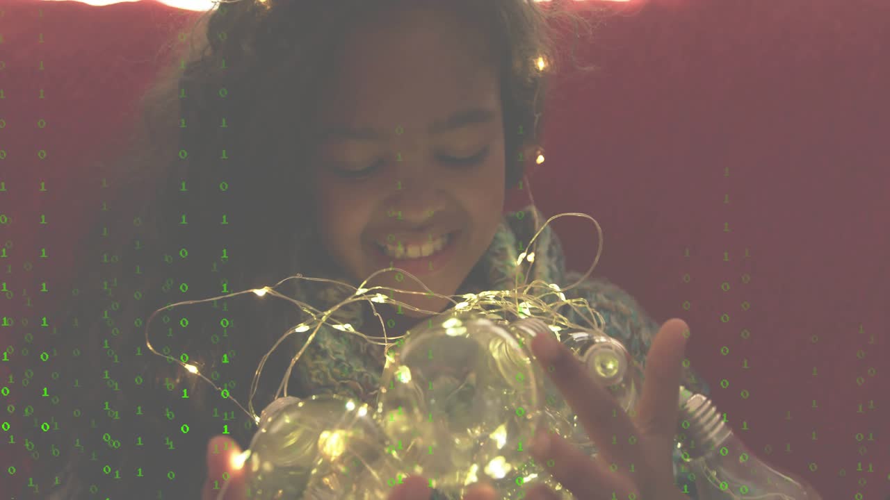 Girl unfolding light string and activating bulbs while binary overlay enhancing tech exploration