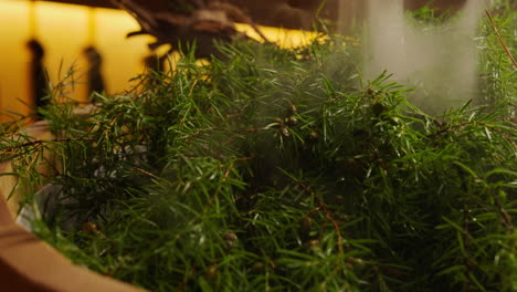 steaming juniper berries in a wooden bowl