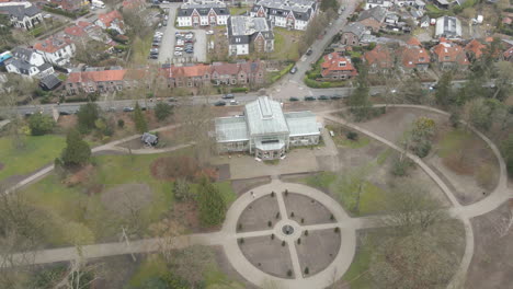 high aerial of old indoor botanic garden in a small green park