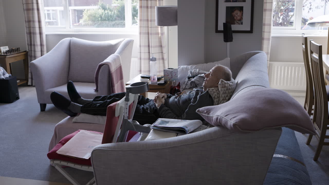 An elderly man relaxing in his living room