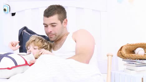 father and son lying on a bed