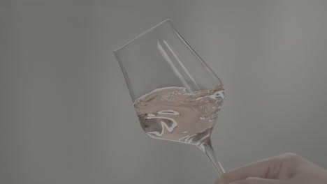rose orange or white wine bottle and glass against a sunset in a peaceful vineyard, pouring of ecological natural wine. cheers, hands with wine glasses, drinking alcohol.