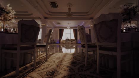 dolly shot revealing luxurious elegant restaurant interior just before a party begins, marble reflections, sunlight through the windows