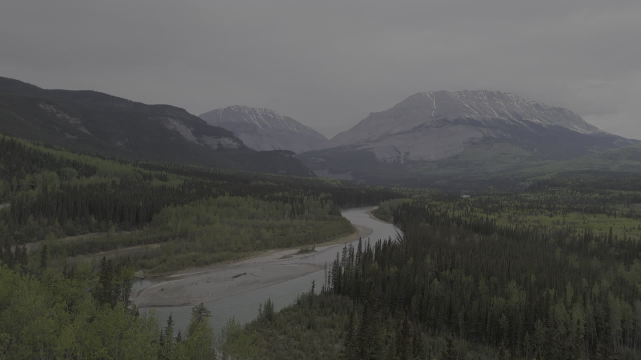 A winding river flows through the majestic Northern Rockies