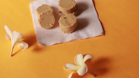 plate full of oatmeal cookies with sesame seeds being snatched up by four children