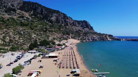 tsambika beach in faliraki, rhodes in greece filmed with the drone from above with mediterranean sea in the summer holiday