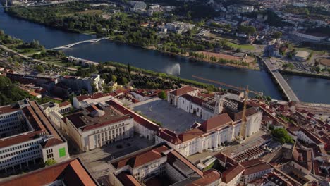 coimbra, portugal, focusing on the paço das escolas, university courtyard, and mondego river with prominent bridges - drone