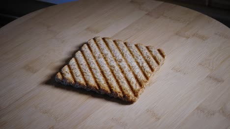 slice of toasted whole grain bread on wooden board