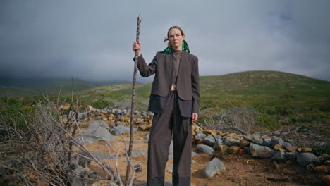 outdoor tourist posing mountains under overcast sky. contemplative hiker travel