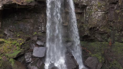 An-aerial-view-of-Melinclourt-Waterfall-on-an-overcast-day,-Neath-Port-Talbot,-South-Wales