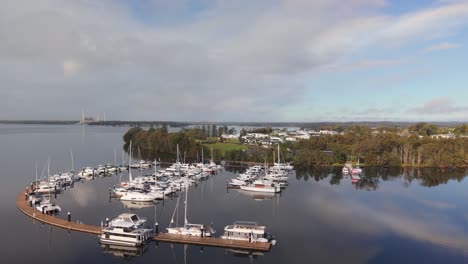 trinity point marina filled with yachts and boats along waterfront in new south wales, establishing medium orbit