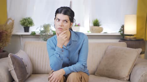 Young-woman-looking-thoughtfully-at-camera.