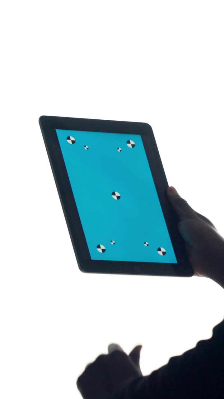 Hands Swiping on a Digital Tablet with Blue Screen