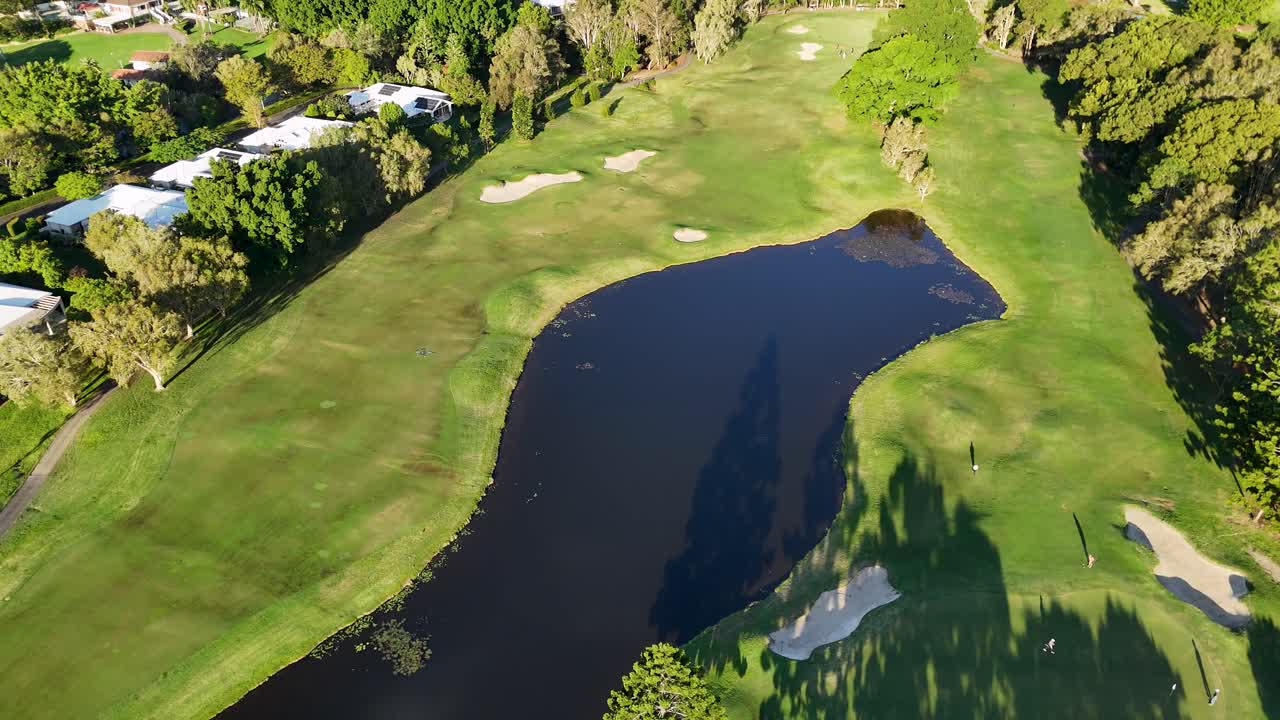 Drone captures sweeping views of a lush golf course in Gold Coast, Australia, highlighting fairways, greens, and surrounding nature