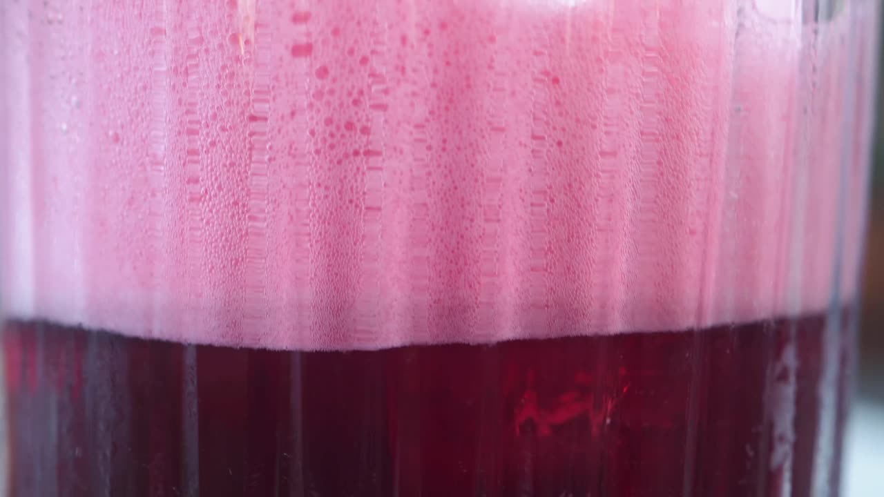 Close-up of a Pink and Red Frothy Drink