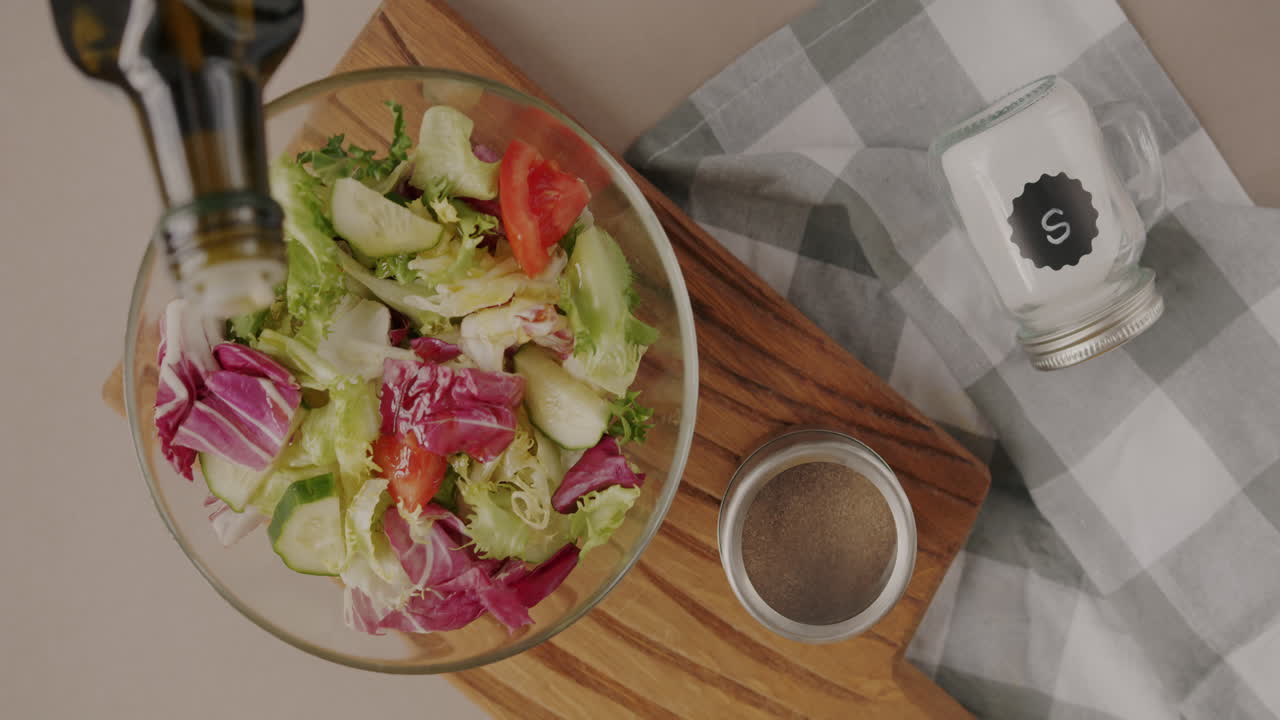 Preparing a fresh salad with olive oil