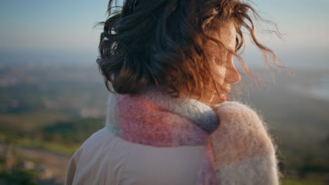 girl enjoy windy landscape looking on evening nature closeup. woman traveler