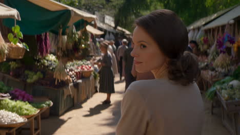 a woman walking through a bustling outdoor market