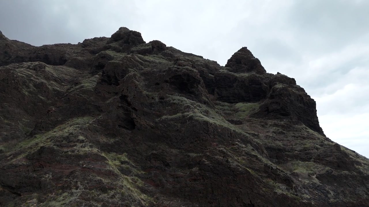 Aerial drone close up of the jagged volcanic peaks of Santo Antao, Cabo Verde. A dramatic mountain landscape featuring ancient rock formations