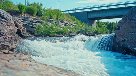 water flowing in the river under the bridge. - static shot