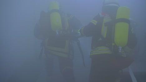 two german fireman looking for missing people in haze