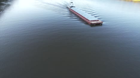 a towboat pushes a single barge south on the mississippi river-1