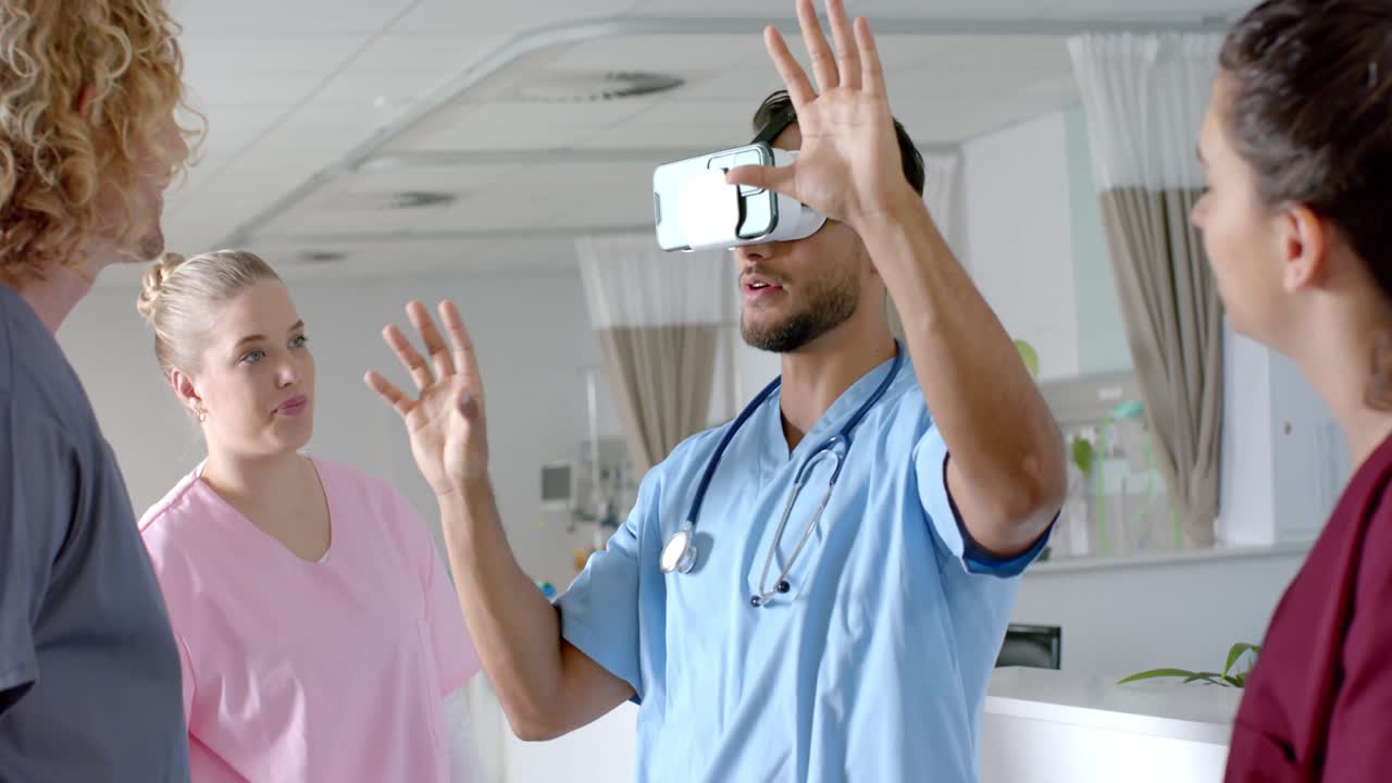 Biracial male doctor using vr headset with diverse doctors at hospital ...