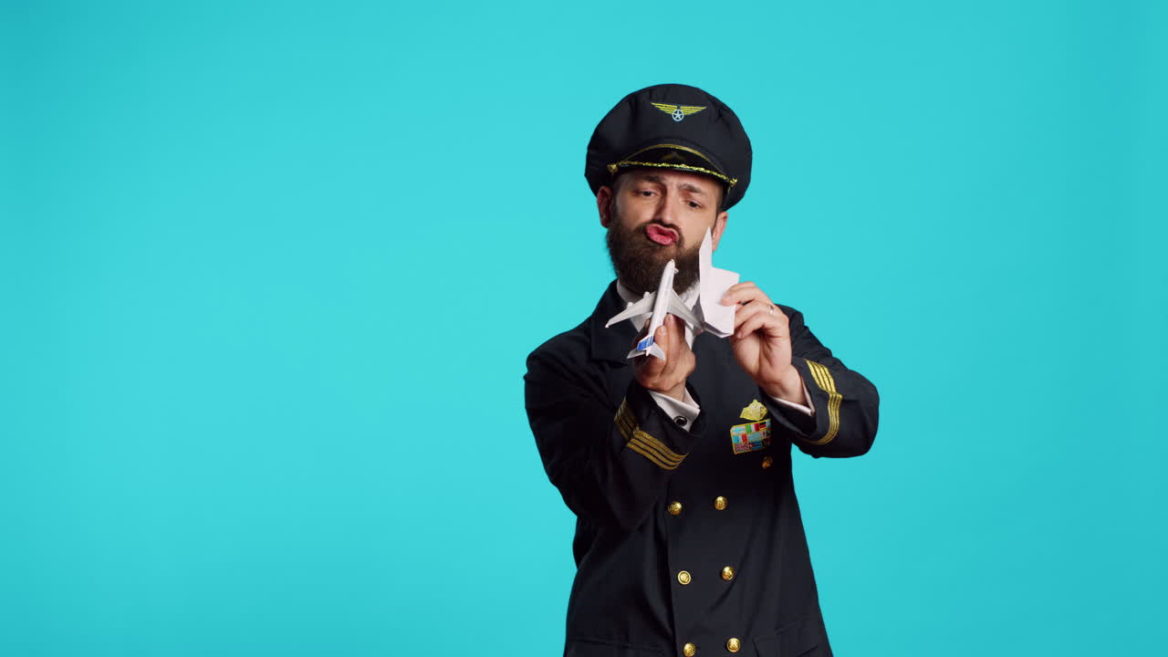 Caucasian man having fun with origami and toy aircraft