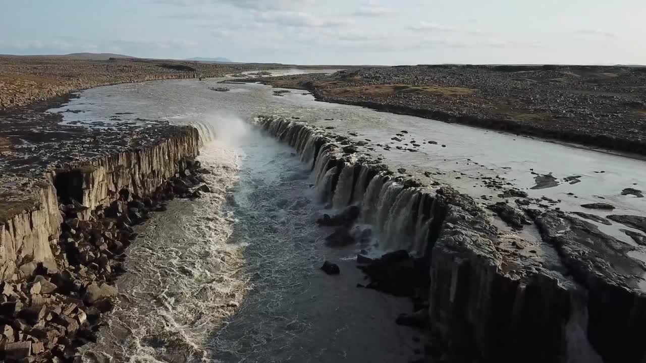 Aerial perspective captures the raw beauty of Selfoss waterfall in Iceland. Showcasing the water cascading over basalt columns into a powerful river. Creating a dramatic display of nature's force