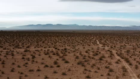 aerial view of the mojave desert basin with the rugged mountains on the horizon