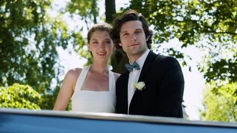 just married couple in a blue convertible car